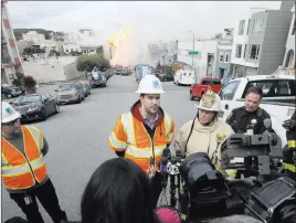  ?? Jeff Chiu The Associated Press ?? Fire Chief Joanne Hayes-white, second from right, listens as Pacific Gas &amp; Electric spokesman Paul Doherty speaks to reporters about a fire Wednesday on Geary Boulevard in San Francisco.