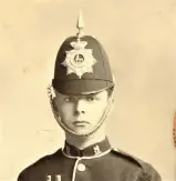  ??  ?? Member of the Rugby School Cadet Corps wearing blue helmet and star plate