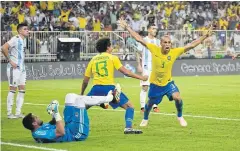  ?? AFP ?? Brazil defender Miranda, right, celebrates after scoring against Argentina.