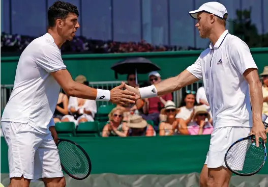  ??  ?? Friends... and rivals: England’s Dominic Inglot, right, with Croatian partner Franko Skugor at Wimbledon