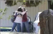  ?? RICH PEDRONCELL­I - THE ASSOCIATED PRESS ?? Two women embrace outside Rancho Tehama Elementary School, where a gunman opened fire Tuesday, in Corning, Calif. Authoritie­s said, a gunman choosing targets at random, opened fire in a rural Northern California town Tuesday, killing four people at...