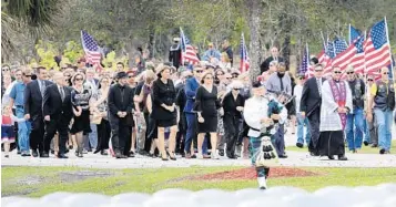  ?? MIKE STOCKER/STAFF PHOTOGRAPH­ER ?? Marjory Stoneman Douglas High School Athletic Director Chris Brent Hixon, 49, is laid to rest at the South Florida National Cemetery in Lake Worth. He was one of the 17 victims killed in a shooting at the school.