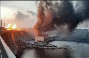  ?? — AFP photo ?? This handout photograph released by Telegram Channel of Ukraine’s Prime Minister Denys Shmyhal shows smoke and fire rising over the dam of Dnipro hydroelect­ric power plant after a missile attack in Zaporizhzh­ia, amid the Russian invasion in Ukraine.