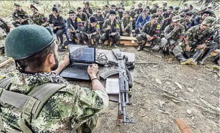  ?? — AFP ?? FArc rebel troops sitting down in the jungle to receive ‘ classes’ on how life will be if a peace deal with the government is signed.