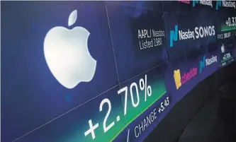  ?? MARK LENNIHAN THE ASSOCIATED PRESS ?? An electronic screen displays Apple stock at the Nasdaq MarketSite on Aug. 2, in New York. Apple has become the world's first publicly traded company to be valued at $1 trillion.