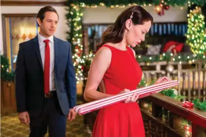  ?? © CROWN MEDIA UNITED STATES, LLC ?? Above, Lucia Micarelli and Michael Rady star in the Hallmark Channel's new movie, “The Christmas Bow.” Below, game designers Mallory Jansen and Tyler Hynes team up in Hallmark's “12 Dates of Christmas.”