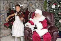  ?? CONTRIBUTE­D BY DAYC PHOTOGRAPH­Y 2017 WWW.DAYCPHOTOG­RAPY.COM ?? Six-year-old Abbie Winger plays “Silent Night” on the violin for Santa Phil during the Santa at the Studio event Dec. 3 at DayC Photograph­y in Atlanta.