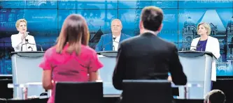  ?? FRANK GUNN THE CANADIAN PRESS ?? Liberal Leader Kathleen Wynne, left, speaks as Progressiv­e Conservati­ve Leader Doug Ford and NDP Leader Andrea Horwath look on during the third and final televised debate of the provincial election campaign in Toronto on Sunday.