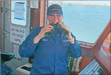  ?? COURTESY OF LT. J.G. CECELIA HOSLEY ?? Lt. j.g. Cecelia Hosley laughs Tuesday on the bridge of the Coast Guard cutter Angela McShan after using binoculars to monitor vessel traffic in Cape May Harbor.