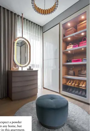  ??  ?? This page: The walk-in wardrobe features cabinetry with gold trimming and built-in lighting to showcase the wife’s favourite bags and shoes; the master bathroom is a tranquil space opulently clad in marble