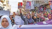  ?? (AFP) ?? Syrian-kurdish demonstrat­ors raise pictures of people killed during conflict, as they protest in the Syrian city of Qamishli, on Sunday
