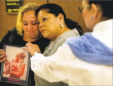  ?? Photograph­s by Al Seib Los Angeles Times ?? PEARL NELSON, left, holds a photo in 2014 of her mother, Audrey Nelson, a victim of serial killer Sam Little, who said he killed 93 people across the U.S. Police in L.A. County are seeking to identify 16 of his victims.