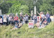  ?? JOHN MUSICK/FOR THE NEWS ?? Supporters wave to boats taking part in the Land and Sea rally held in Pictou.