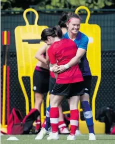  ?? DARRYL DYCK/THE CANADIAN PRESS ?? Canada goalkeeper Erin McLeod, back, jokes with Diana Matheson during a FIFA Women’s World Cup soccer practice session in Vancouver on Wednesday.