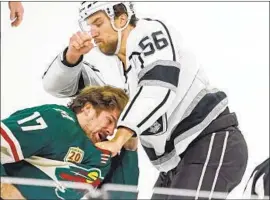  ?? Jim Mone Associated Press ?? KURTIS MacDERMID (56) throws a punch as the Wild’s Marcus Foligno ducks. It was the fourth game between the teams in the season’s first two weeks.