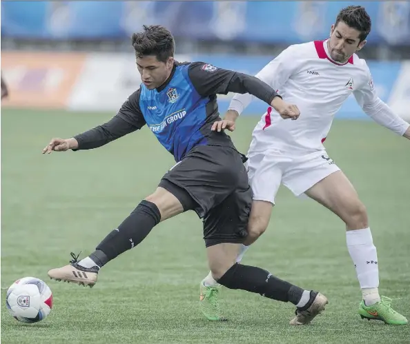  ?? SHAUGHN BUTTS ?? FC Edmonton’s Dustin Corea, left, is challenged by the San Francisco Deltas’ Tyler Gibson on Sunday at Clarke Field. The Deltas won 1-0.