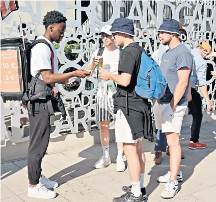  ?? ?? Easy access: A mobile vendor dispenses beer to fans who have turned up to watch the action at the French Open