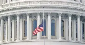  ?? REUTERS ?? The US flag flies at half-mast in front of the US Capitol dome during the second day of former president Donald Trump's impeachmen­t trial, at the Capitol Hill in Washington, DC on Wednesday.