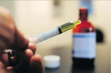  ?? DAVID ZALUBOWSKI/AP FILES ?? A syringe is loaded with a dose of CBD oil in a research lab at Colorado State University in Fort Collins, Colo. Companies are taking notice of cannabidio­l or CBD, a compound derived from pot heralded for its therapeuti­c effects, as restrictio­ns are showing signs of easing.