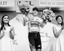  ?? CHRISTOPHE ENA THE ASSOCIATED PRESS ?? Belgium's Greg van Avermaet, wearing the overall leader's yellow jersey, celebrates on the podium after the third stage of the Tour de France.