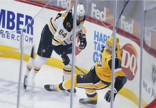  ?? Associated Press ?? Evgeni Malkin, right, is “week-to-week” after he was injured on a hit along the boards in Tuesday’s 2-1 loss to the Bruins.