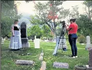  ?? Jamie Boyle/ Courtesy photo ?? Volunteer actress Brett Landis, a Boulder County Legal Services attorney, plays the role of Nannie Baird during a filming for Historic Boulder's “Meet the Spirits,” as Mariah Diaz, of Front Porch Studios, films in September. Nannie Baird, who is buried in Columbia Cemetery, was purportedl­y poisoned by her husband for life insurance money a few months after they were married in 1902. The pre-recorded segments, shot in Columbia Cemetery, will be available to stream today at 6 p.m. through Nov. 25.