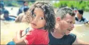  ?? REUTERS ?? A file photo of a migrant from Honduras holding his daughter while crossing the Suchiate River into Mexico from Guatemala.