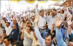  ?? PHA LINA ?? CNRP members raise their hands to vote in favour of new leadership at the party’s extraordin­ary congress last month in Phnom Penh.