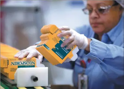  ?? BLOOMBERG ?? An employee stacks Johnson & Johnson Neosporin brand boxes on the production line at the J&J consumer healthcare products plant in Lititz, Pennsylvan­ia, the United States.