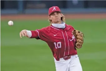  ?? AP PHOTO/VASHA HUNT ?? Alabama infielder Jim Jarvis throws to first during a home game against Southern Miss on March 23. The Crimson Tide seemed an unlikely NCAA tourney team just a month ago but will host a regional this weekend.