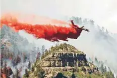  ?? PTI ?? A plane drops fire retardant chemicals on the fire near Durango, Colorado. More than 800 firefighte­rs are battling the blaze.