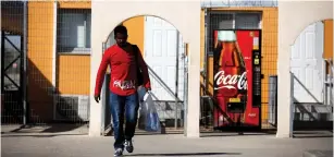  ??  ?? AN AFRICAN MIGRANT walks out of the Holot detention center last month.