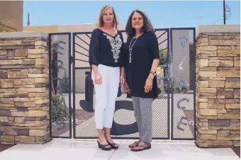  ?? ADOLPHE PIERRE-LOUIS/JOURNAL ?? Melissa DeaverRive­ra, left, and Diana Trujeque, right, from the Children’s Cancer Fund of New Mexico pose in front of Erin’s Place, a facility offering hospice and long-term care for pediatric cancer patients that was named for Trujeque’s son.