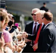  ?? (Photo by Andrew Harnik, AP) ?? President Donald Trump greets guests on the tarmac after he arrived on Air Force One at General Mitchell Internatio­nal Airport in Milwaukee, Wis., Tuesday, June 13, 2017.