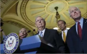  ?? THE ASSOCIATED PRESS ?? Senate Majority Leader Mitch McConnell of Kentucky, second from left, standing with, from left, Sen. Roger Wicker, R-Miss., Sen. John Thune, R-S.D., and Senate Majority Whip John Cornyn, of Texas, listens to a question during a news conference on...