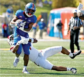  ?? AP Photo/Charlie Riedel ?? ■ Kansas running back Pooka Williams Jr. (1) is pulled down by Rutgers defensive back Saquan Hampton during the first half in Lawrence, Kan. Williams leads Big 12 rushing with 147.7 all-purpose yards per game.