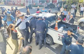  ?? ?? Momento en que policías llevan detenido a Efraín Alegre (hijo), en medio de las protestas.