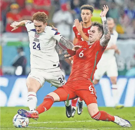 ?? DANIELLE PARHIZKARA­N/ USA TODAY SPORTS ?? Wales defender Joe Rodon ( 6) knocks the ball away against US forward Josh Sargent during the second half of their group stage match Monday.
