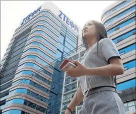  ?? Ng Han Guan Associated Press ?? CONGRESS members from both parties have raised national security concerns, and some have threatened to block any ZTE deal. Above, a building in Beijing.