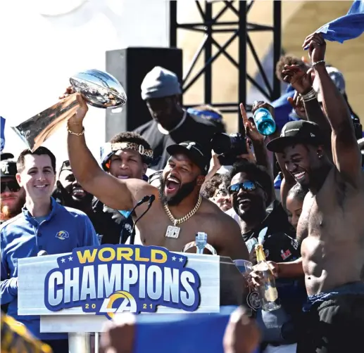  ?? AP ?? Rams defensive lineman Aaron Donald holds up the Vince Lombardi Trophy during the team’s Super Bowl victory celebratio­n Wednesday.