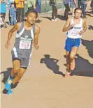  ?? PHOTOS BY JAMES BARRON THE NEW MEXICAN ?? LEFT: Navajo Prep’s Cameron Becenti, left, leads Justin Angel of St. Michael’s. Angel finished ninth to lead the Horsemen.