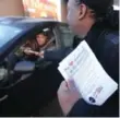  ??  ?? Protesters pass out flyers at the drive-thru of a Lawrence Ave. E. location in Scarboroug­h.