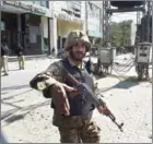  ?? ARIF ALI/AFP ?? A Pakistani soldier cordons off the site of the bomb attack in Lahore yesterday.