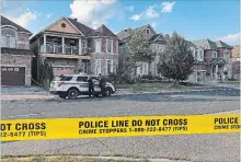  ?? ALANNA RIZZA THE CANADIAN PRESS ?? York Regional police officers stand outside of a home in Markham, Ont. Police say one person is in custody after four bodies were found in a home north of Toronto on Sunday afternoon.