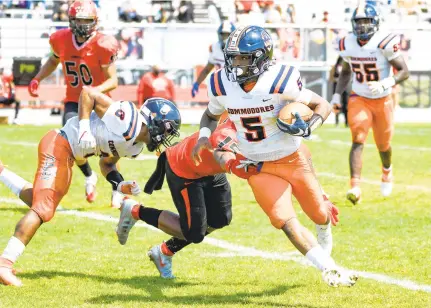  ?? MIKE CAUDILL/FREELANCE ?? Maury’s Ahmarian Granger, right, evades Salem defender Desmond Green, center, during the first half of the Commodores’ 20-7 Class 5 Region A semifinal victory Saturday in Virginia Beach. Granger ran for two touchdowns.