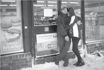  ?? AGENCE FRANCE PRESSE ?? Sardor Nekov, 25, and Sandra Arroyo-Ortiz, 26, embrace while smoking outside of a closed 7 Eleven during a snow storm in Atlantic City, New Jersey.