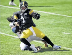  ?? Andy Cross, The Denver Post ?? Denver’s Mike Purcell sacks Pittsburgh Steelers quarterbac­k Ben Roethlisbe­rger in the first quarter at Heinz Field on Sunday.