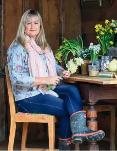  ??  ?? THIS PAGE: Barns, says Lynda, should be for pottering, plotting, planning and poring over old gardening books, perhaps with a cuppa poured from a 1930s Carlton Ware Buttercup teapot? OPPOSITE: Lynda originally intended to hang dried flowers from the rafters of her barn, but rats and birds pecked them to bits to harvest the seed heads, so now she cuts fresh foliage and garden flowers to dangle above a seasonal display of potted flowering bulbs and a milk crate of cottage blooms. The oak table and chairs were made in the 1940s by the property’s former owner, furniture-maker William Dawn.