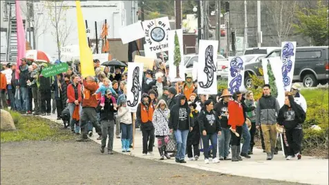  ?? Keith Thorpe/The Peninsula Daily News via AP ?? People march for the environmen­t through West End Park on Saturday in Port Angeles, Wash.