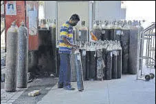  ?? PRAFUL GANGURDE / HT PHOTO ?? A hospital staff arranges oxygen cylinders at the Thane Civil Hospital on Thursday.